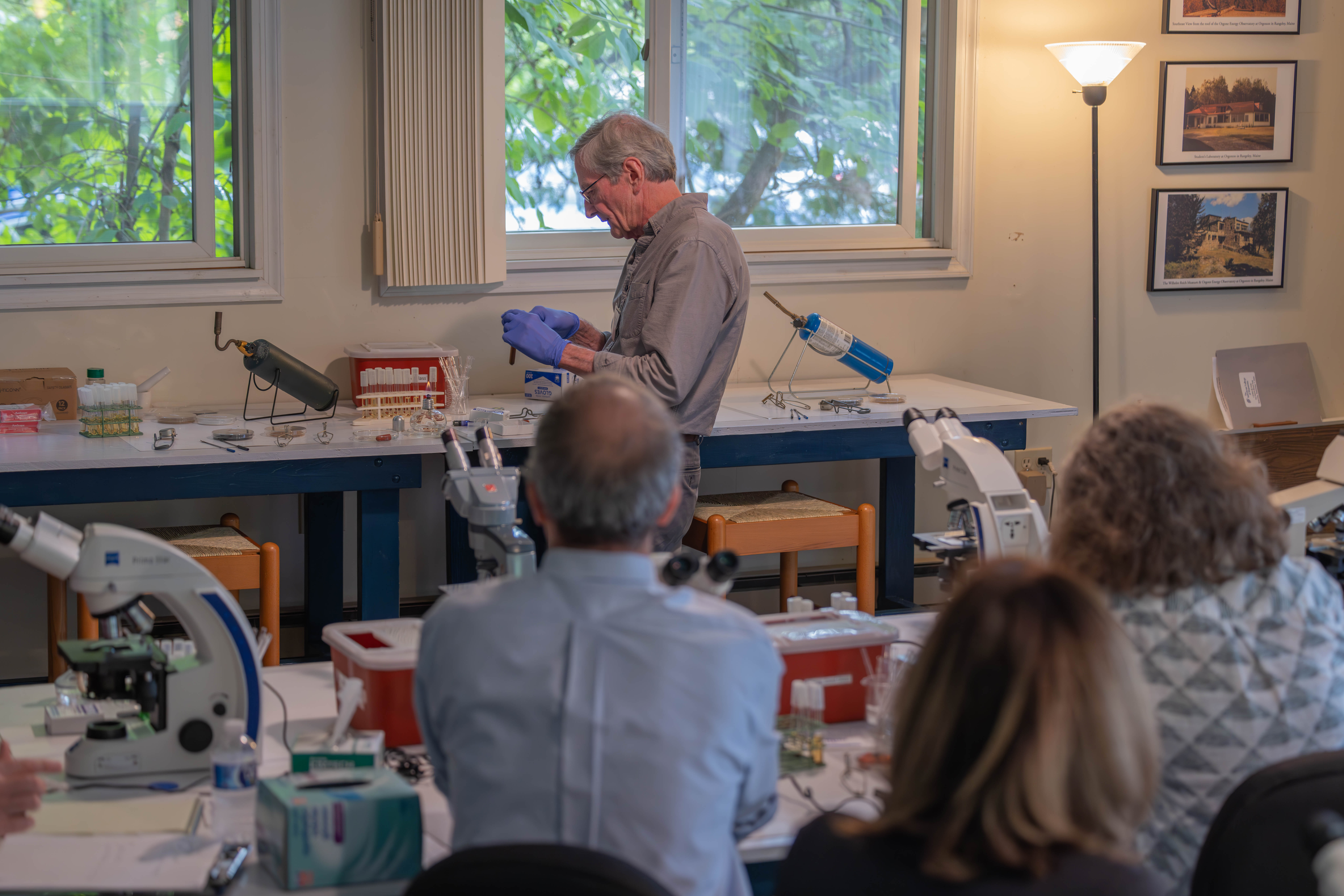 Steven Dunlap showing students laboratory techniques.